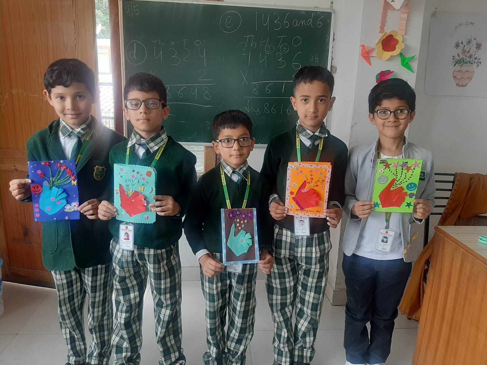 Students proudly showing their art and craft creations