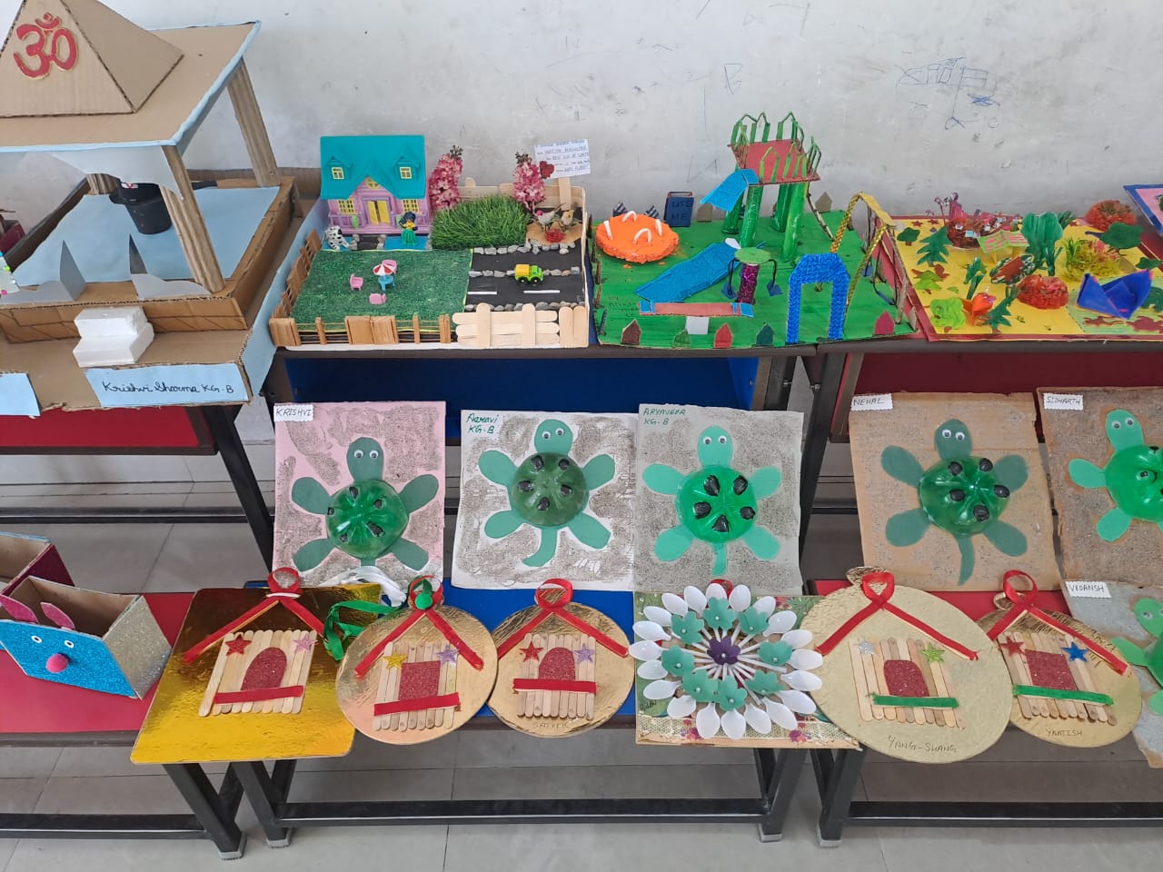 Craft exhibition display with paper models, clay crafts, and mini gardens