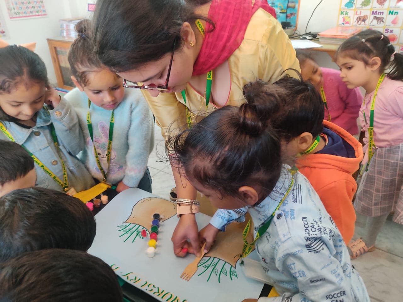 Teacher guiding children in a group painting session