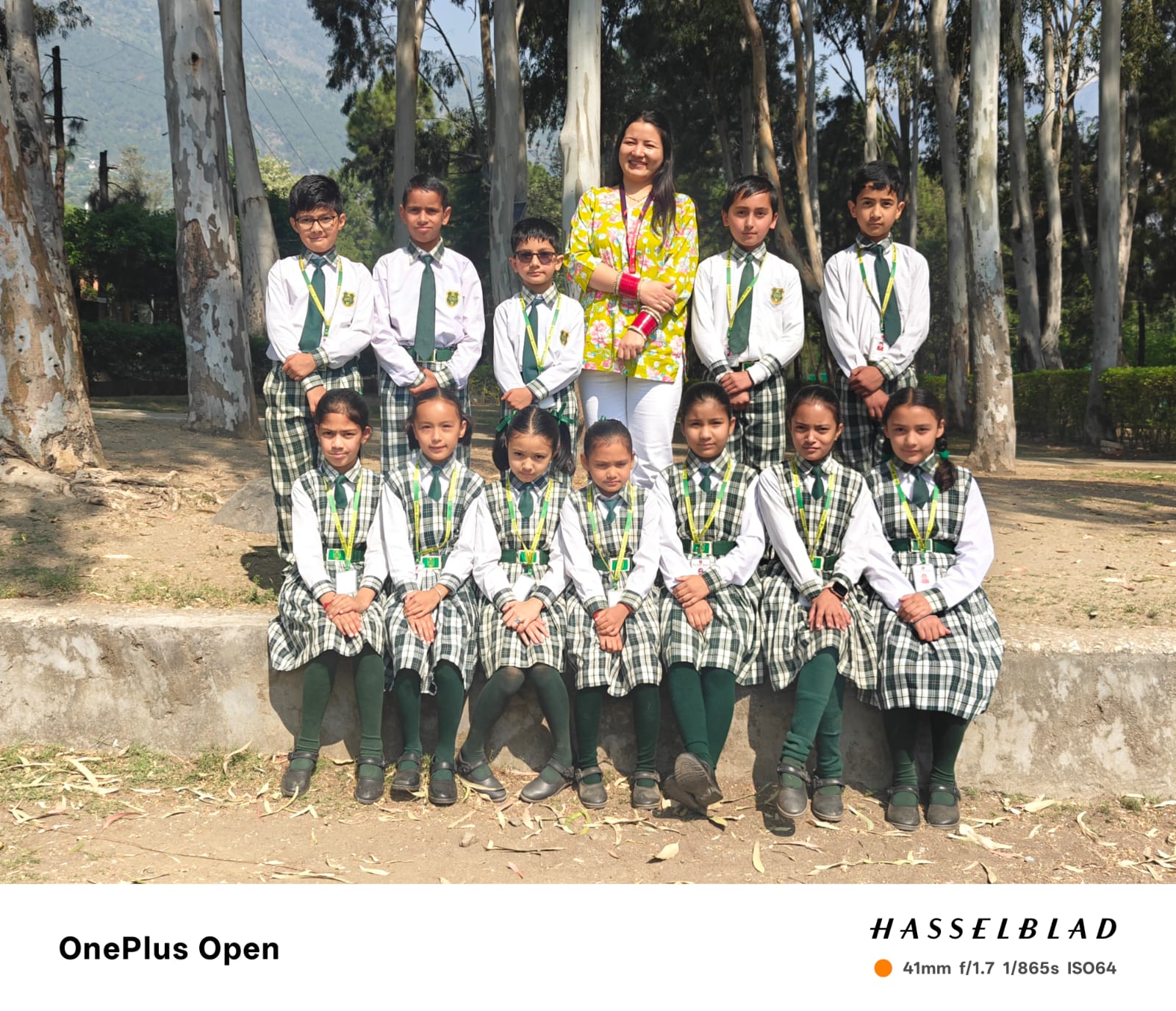 Class 3 group photo — students in green and white uniforms with their teacher