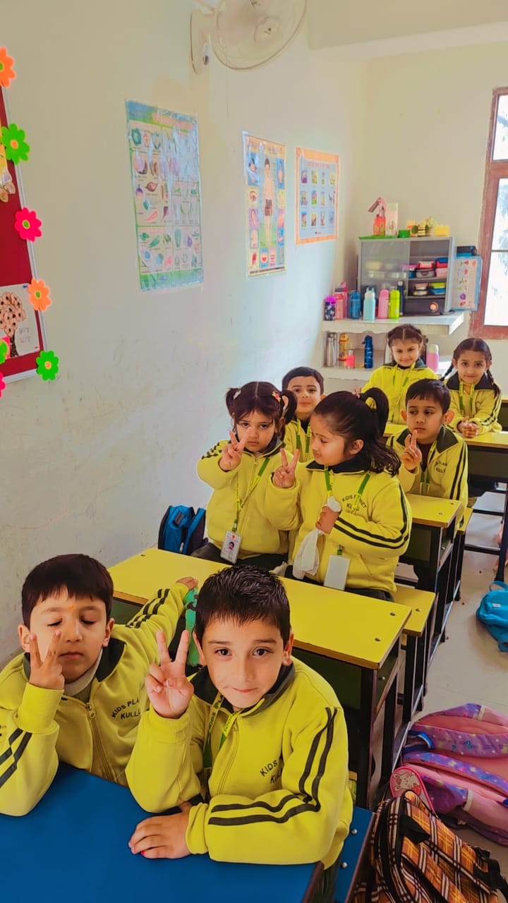 Well-decorated classroom with educational charts and flower arrangements