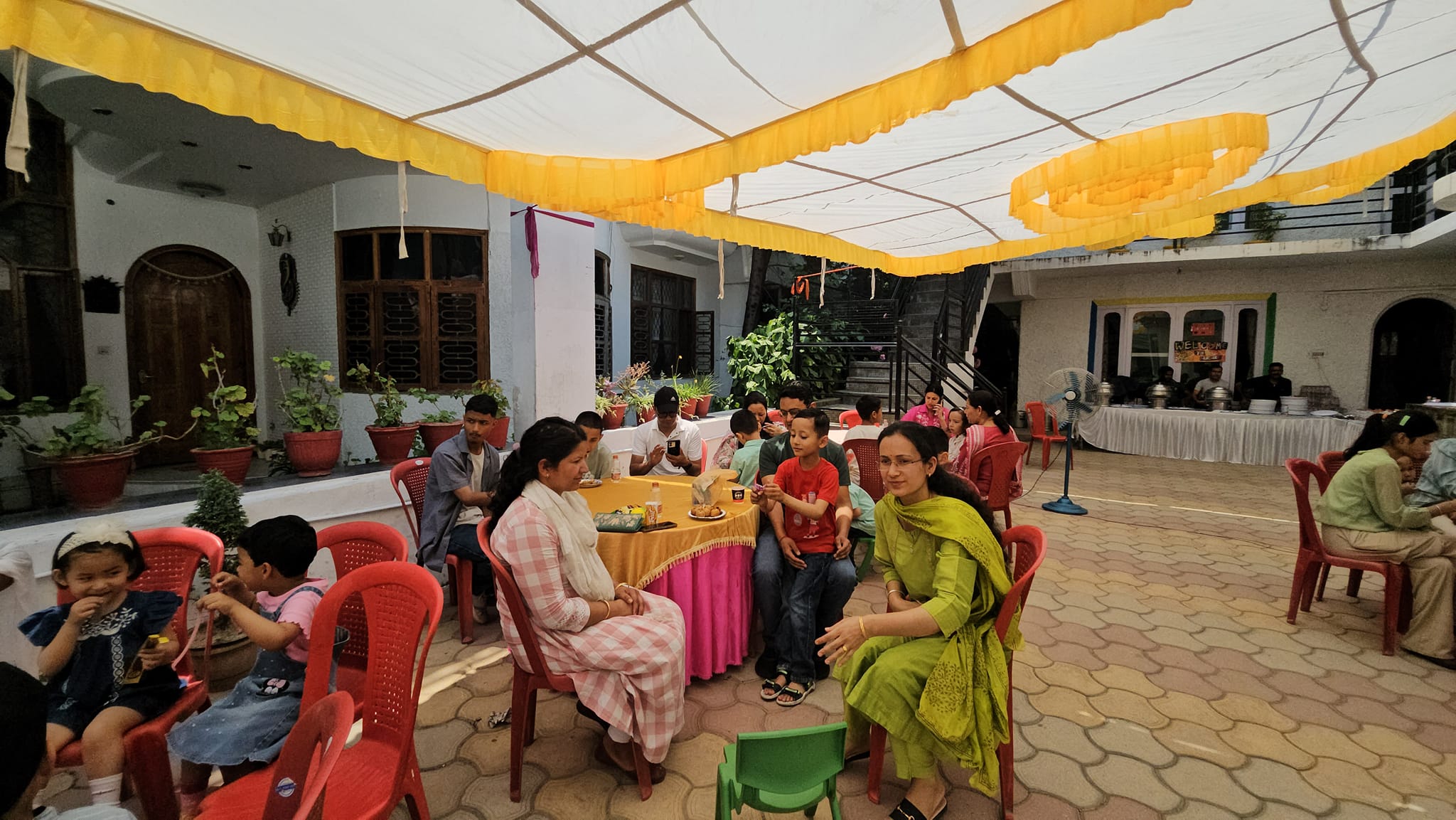 Kids Planet Fete — families enjoying the community fair in the courtyard