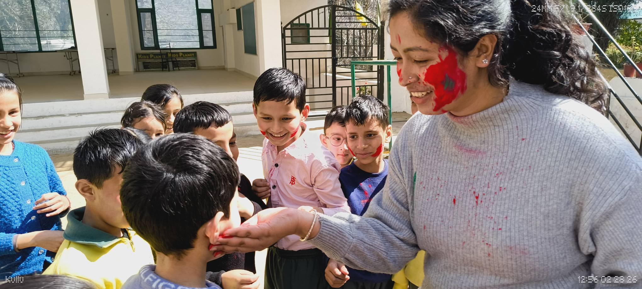 Teacher and students enjoying Holi festivities together