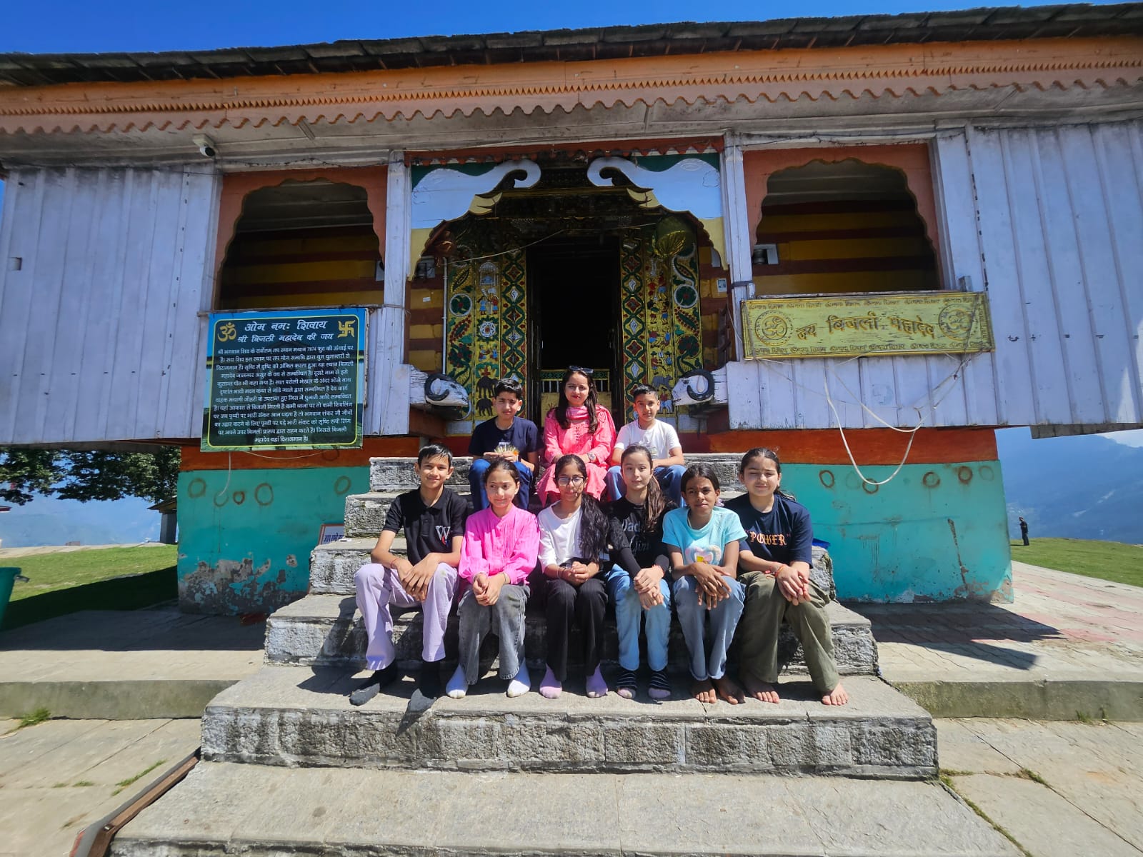 Class 8 temple excursion — group photo at a historic Kullu Valley temple