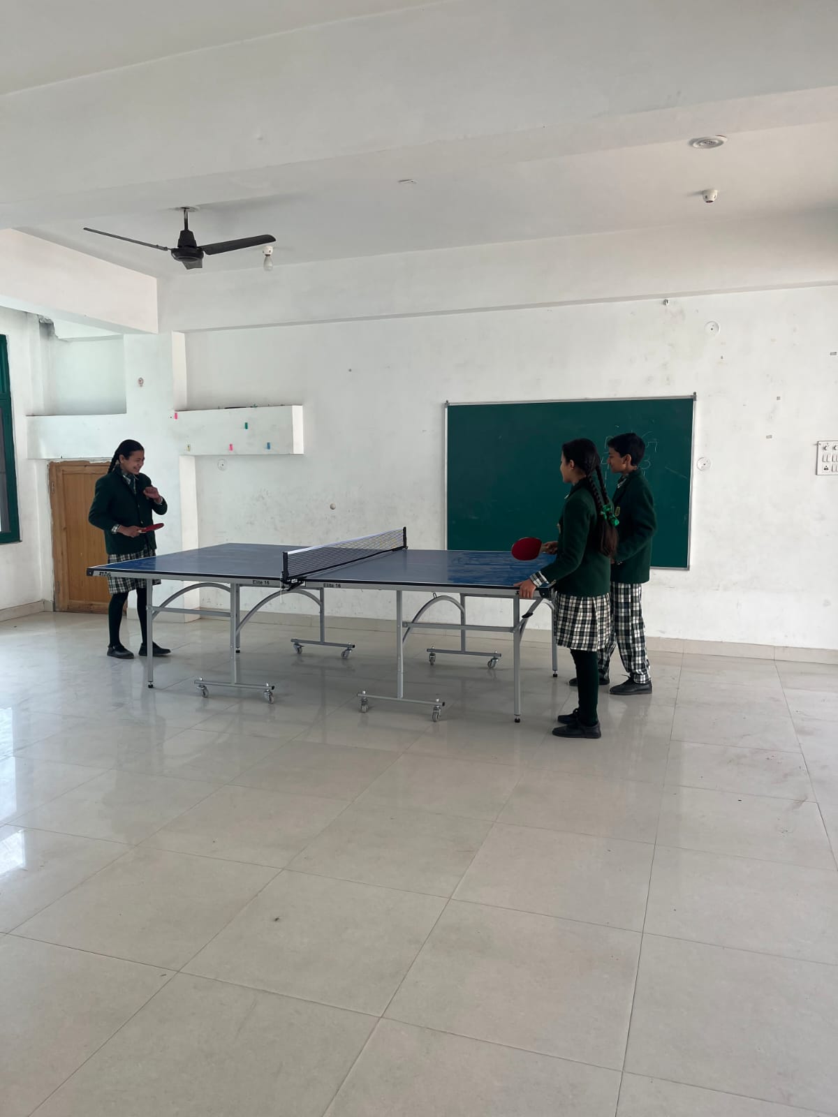 Students playing table tennis in the Kids Planet indoor sports hall
